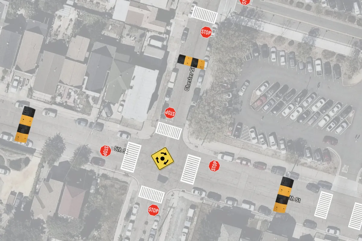 A Felt map over faded satellite imagery marking proposed crosswalks, stop signs, speed bumps and a roundabout at an intersection