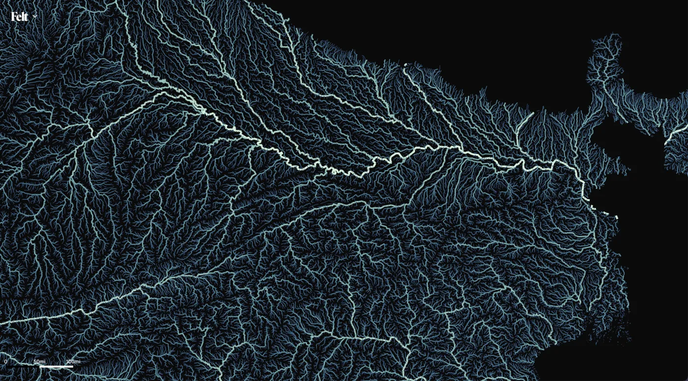 A Felt map of rivers in northern India drawn in light blue lines that grow thicker and brighter with size