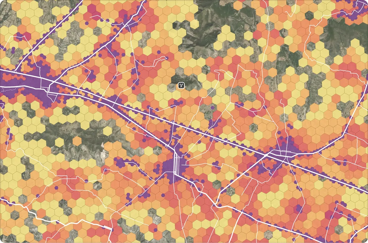 Hexagons colored by density along a road network, over satellite imagery
