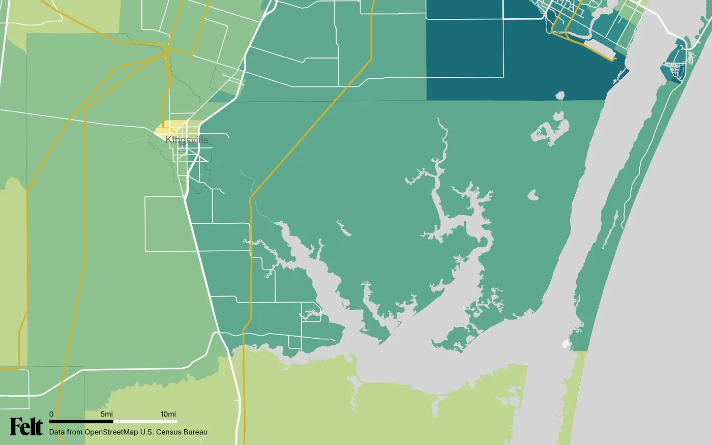 Map of Kleberg County, Texas: the county outlined, with transmission lines over median household income by census tract